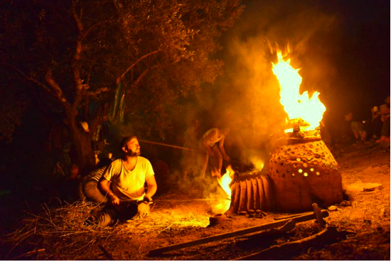 Ilias Christopoulos working in outdoor wood-fired kiln.